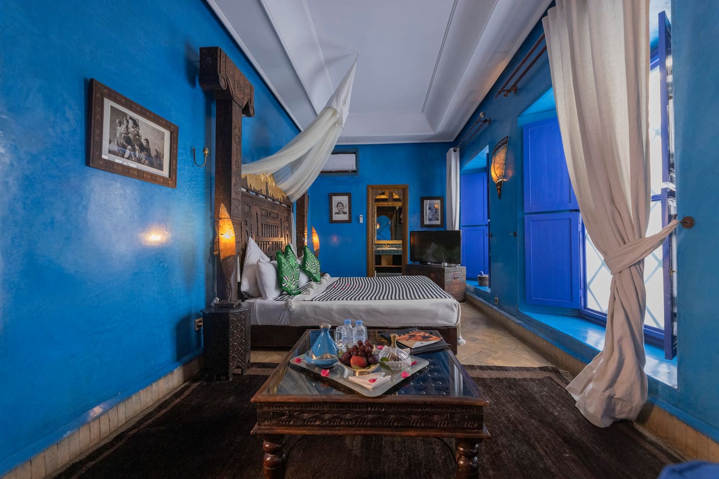 Chambre Ahisia — lit ample face aux moucharabiehs de bois